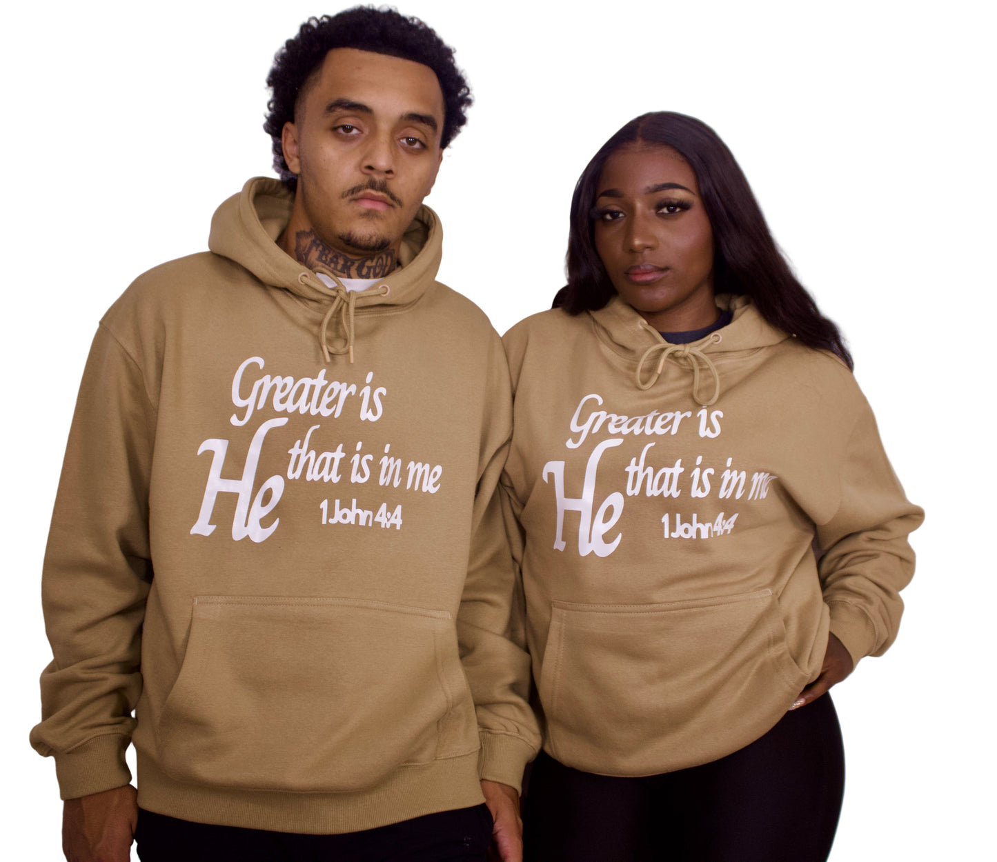 Two people wearing light brown hoodies with text on a plain background