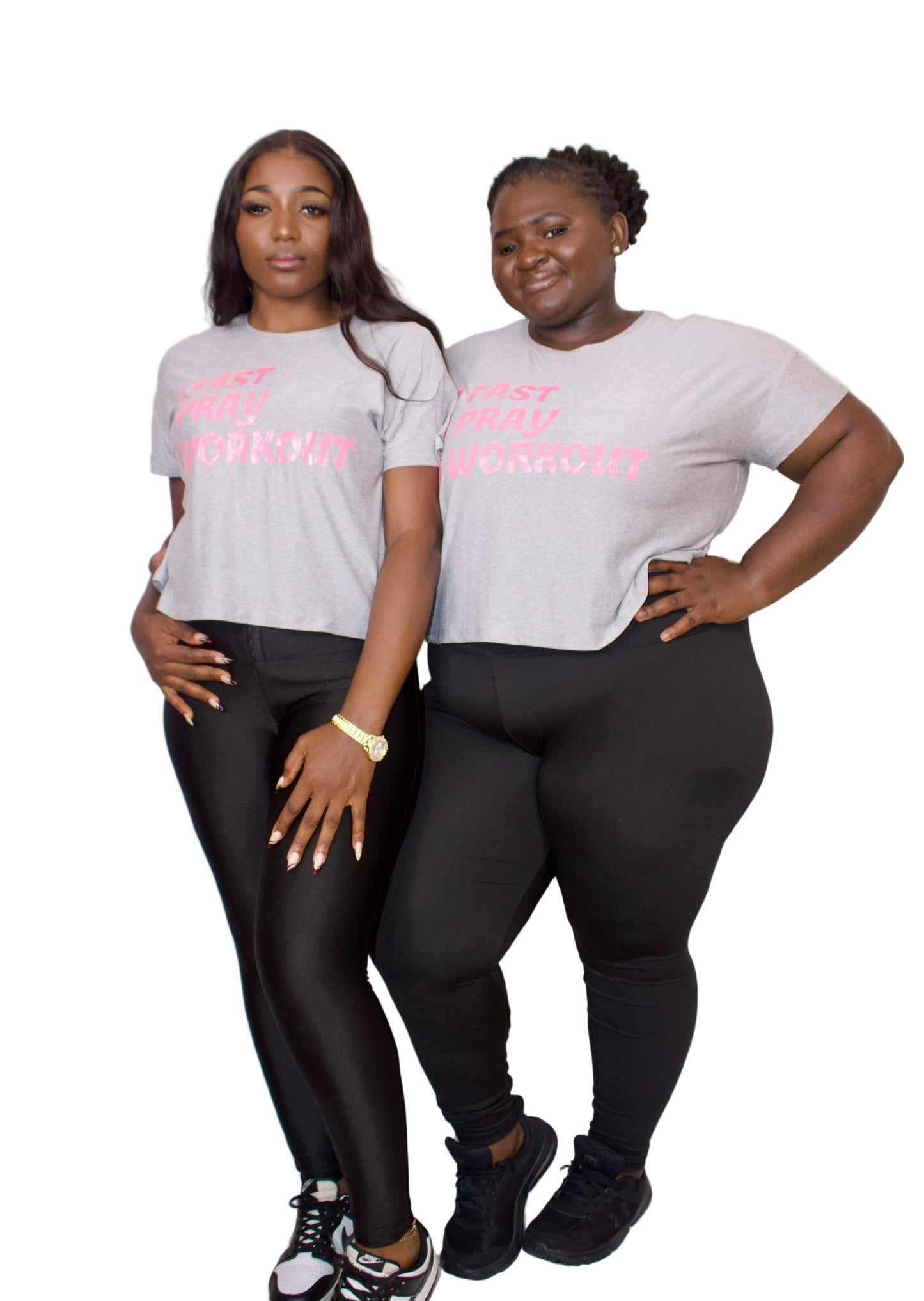 Two individuals wearing matching gray t-shirts with pink text on a white background