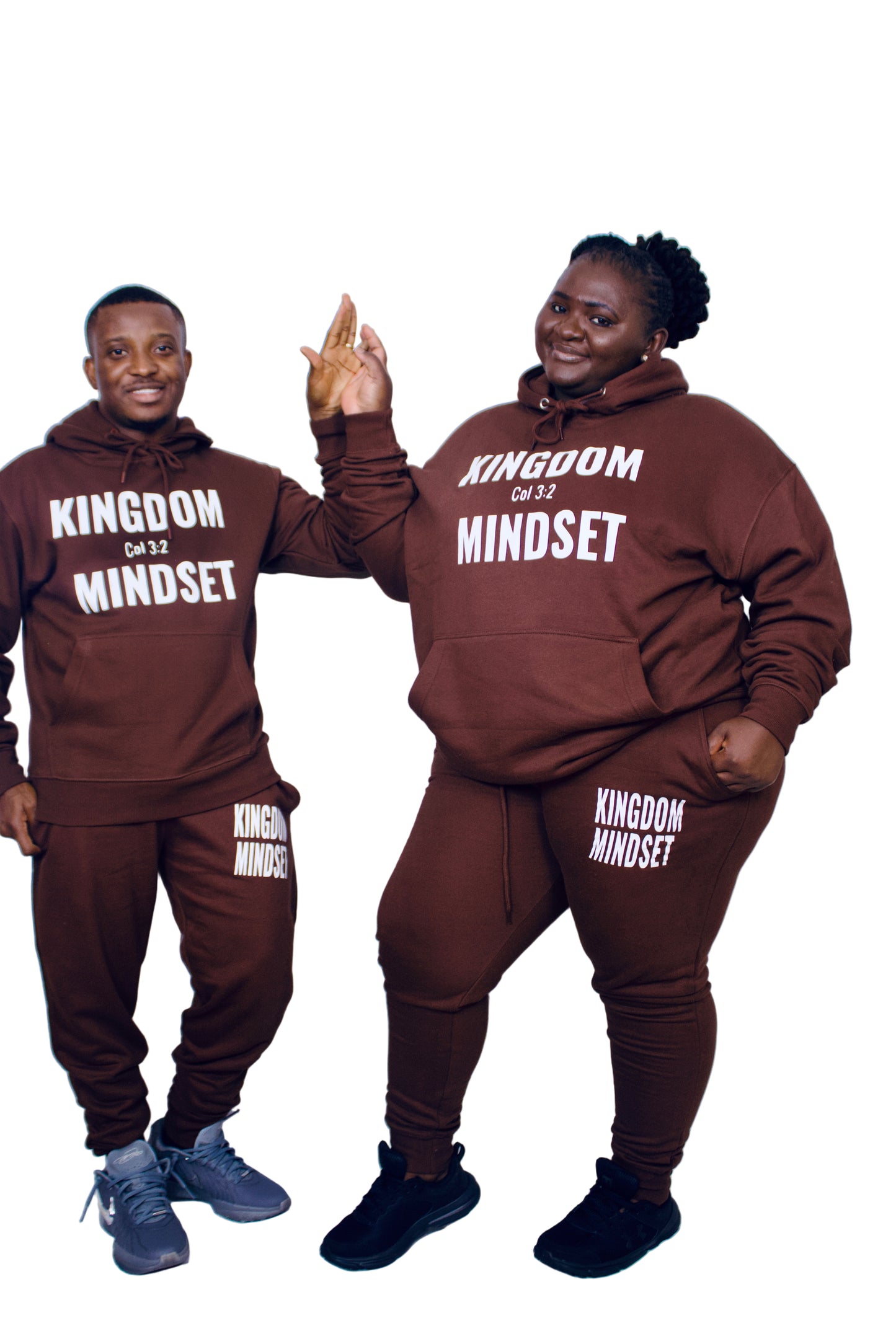 Two people wearing matching brown 'Kingdom Mindset' outfits on a white background