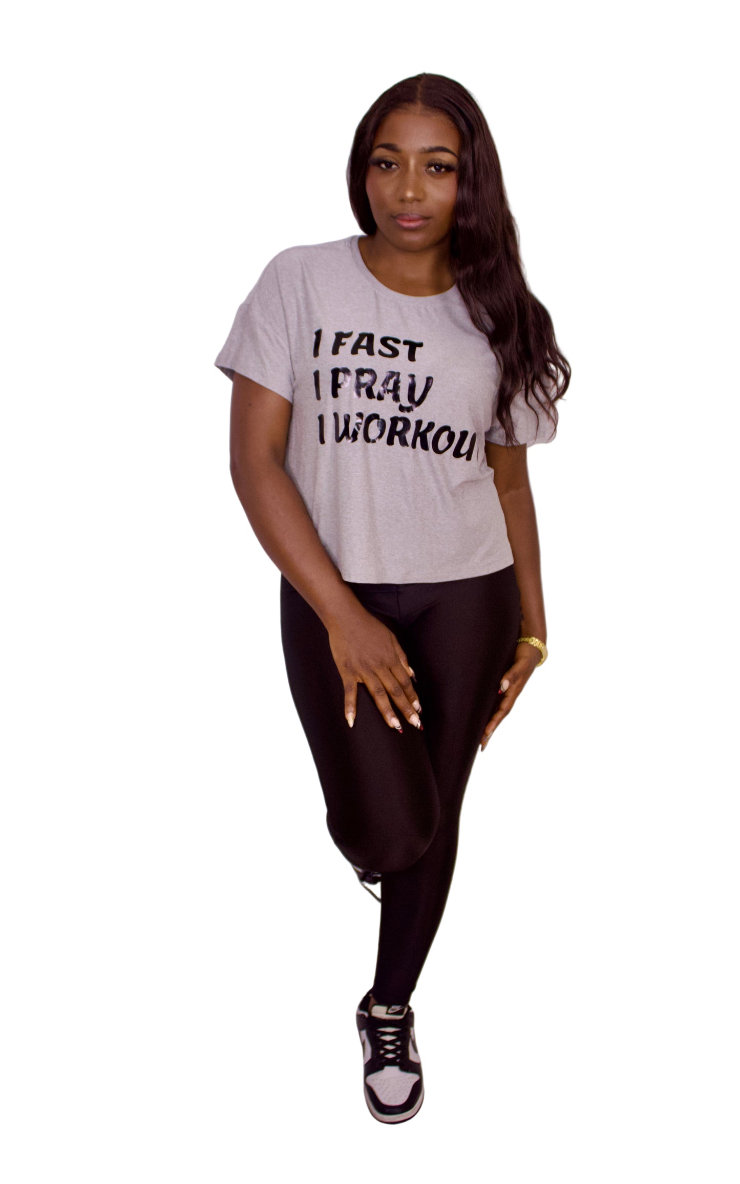Woman wearing a gray t-shirt with text on a plain background