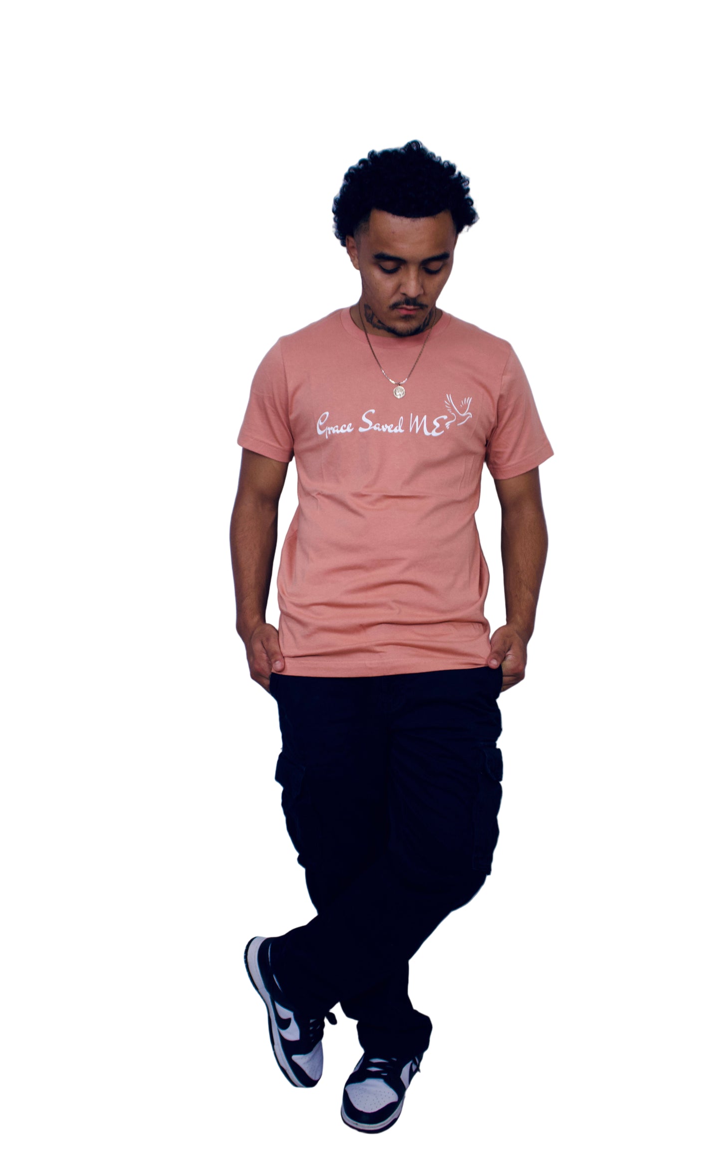 Person wearing a pink t-shirt with text on a plain background