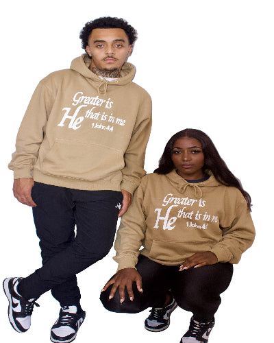 Two people wearing light brown hoodies with text on a white background