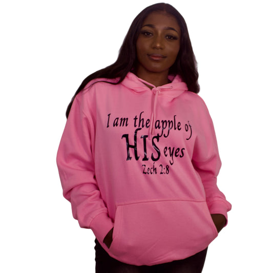Person wearing a pink hoodie with text against a plain background