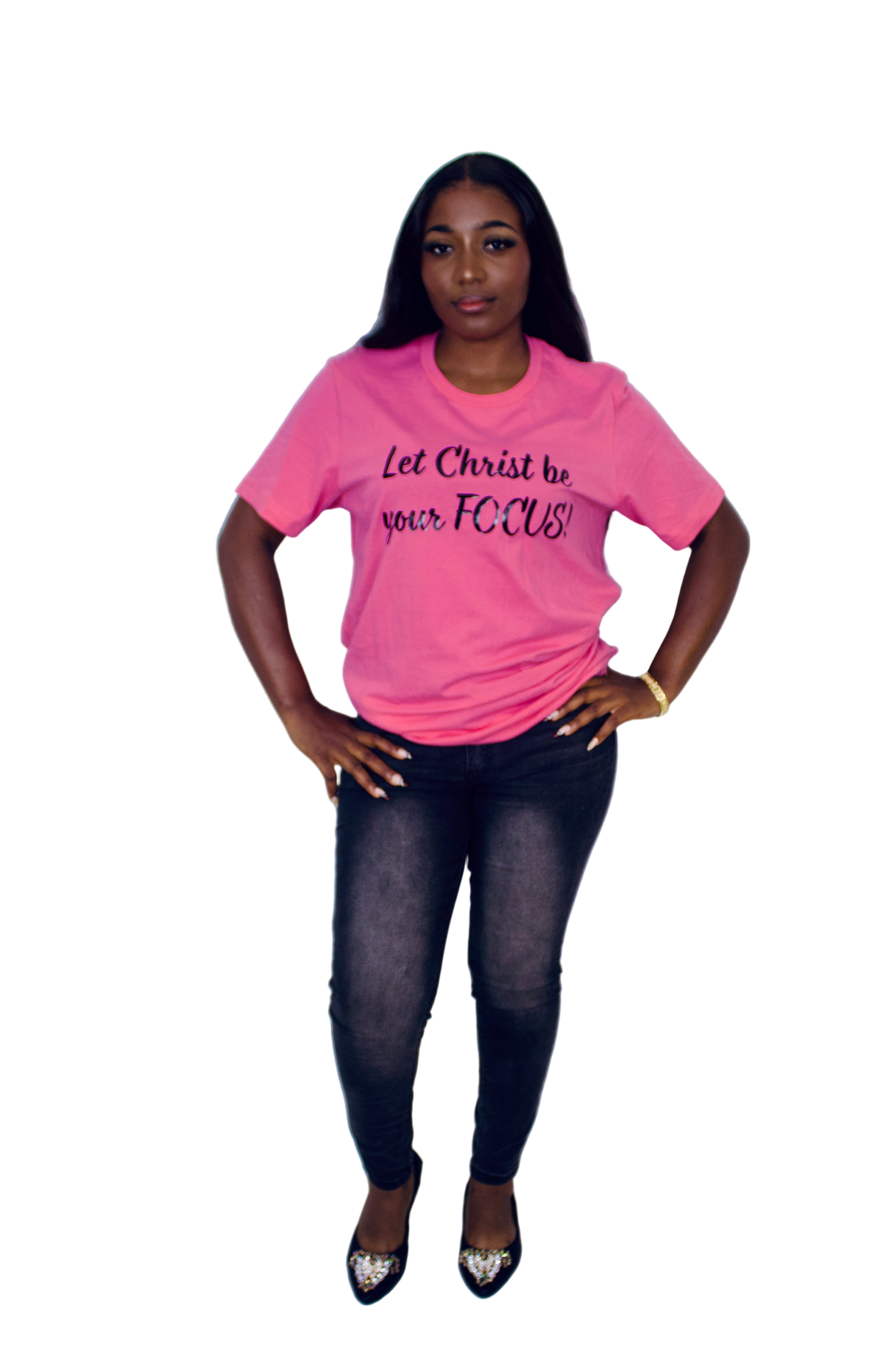 Person wearing a pink t-shirt with text on a plain background