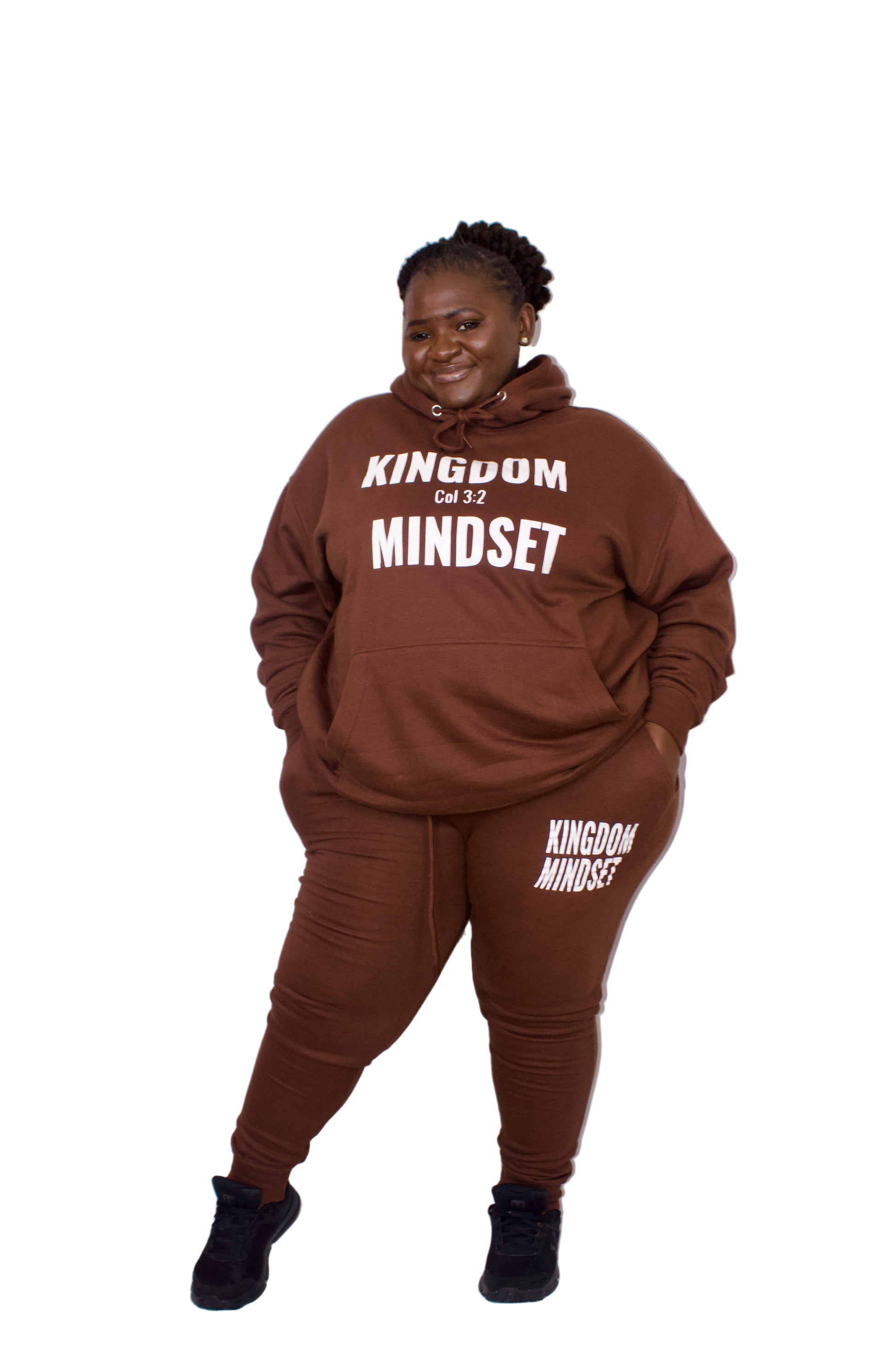 Person wearing a brown 'Kingdom Mindset' hoodie and pants on a white background