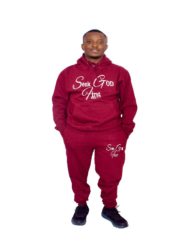 Person wearing a HOODIE 'Seek God First' and pants on a white background