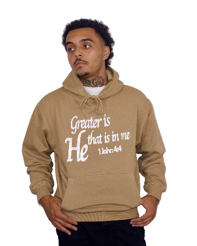 Man wearing a light brown hoodie with text on a plain background