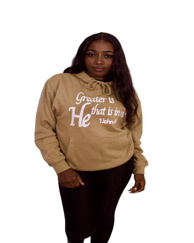 Person wearing a light brown hoodie with text on a plain background