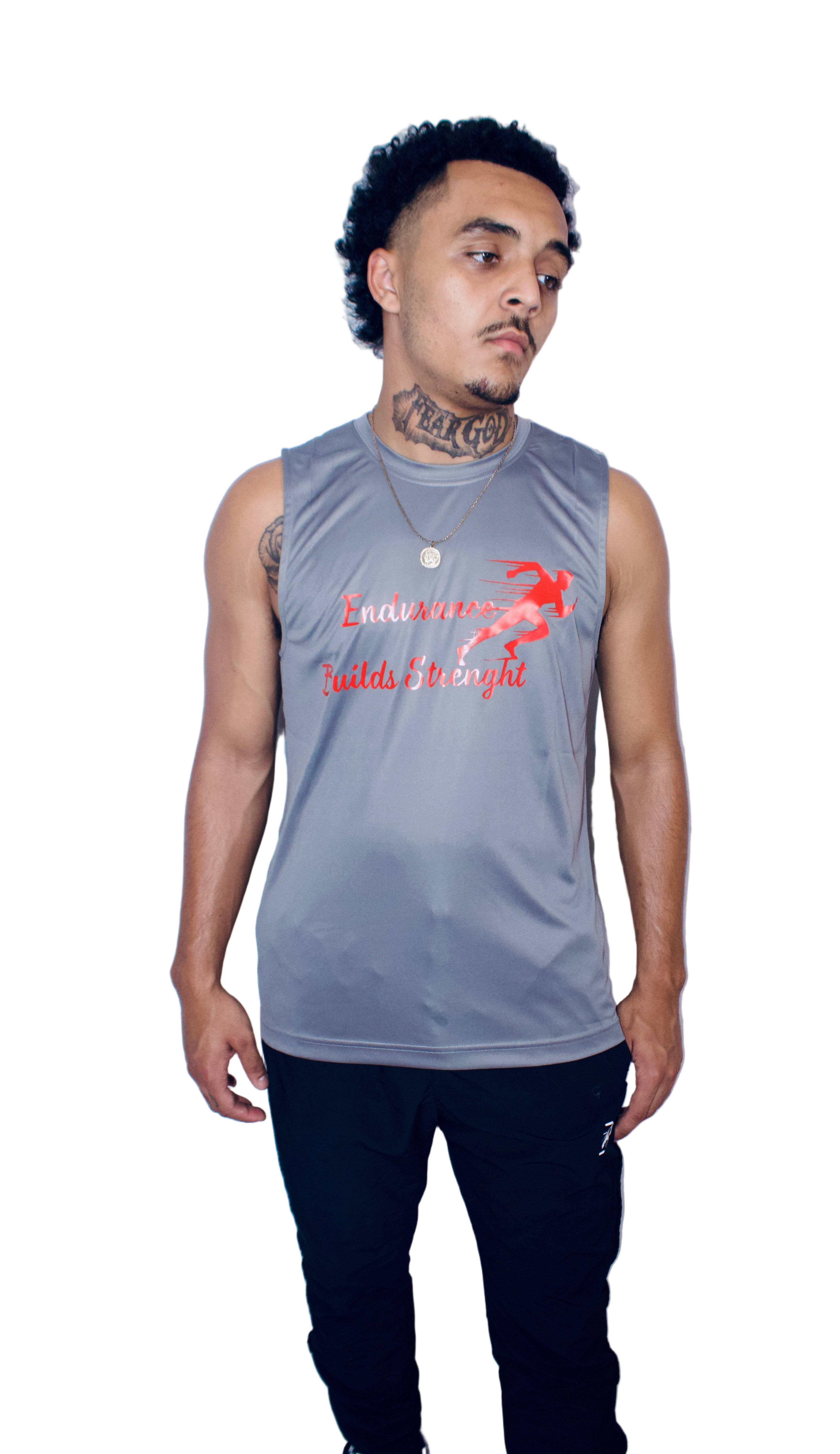 Man wearing a sleeveless gray shirt with red text on a white background